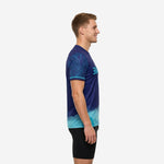 Navy and teal custom soccer training jersey showing left sleeve botanical leaf sublimation detail and cyan cuff stripe