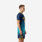 Custom soccer uniform men side view showing navy to teal gradient jersey and matching shorts with gold trim
