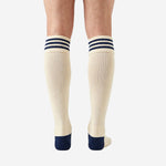 Close detail of custom navy and white soccer socks ribbed cuff with 3 knitted navy blue stripes on cream ivory top band