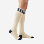 Custom navy and white soccer socks left side view displaying full knee high length ribbed knit construction and navy heel cup detail