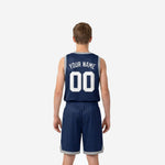 Side view of navy youth basketball jersey and shorts set showing silver-grey armhole binding and shorts side profile on youth model