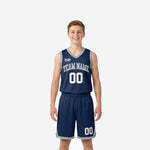 Custom navy youth basketball uniforms front and back view showing silver-grey V-neck binding armhole trim and arced team name on chest