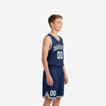 Front view of custom navy youth basketball uniforms with white arced team name front number and matching navy shorts with grey hem band
