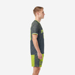 Custom neon green soccer uniforms charcoal geometric side view left, showing sleeve trim and shorts contrast panels