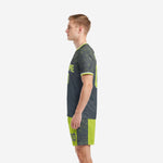 Custom neon green soccer uniforms charcoal geometric side view right, showing back name and shorts leg number