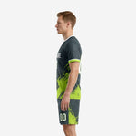 Neon green soccer uniforms in charcoal side view showing back number and shorts splash pattern detail