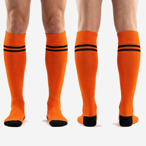 Custom orange and black soccer socks full length view from cuff to toe on adult male model