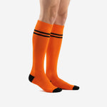 Custom orange and black soccer socks side view displaying over the calf length and black toe cap