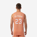 Opposite side view of custom orange basketball jersey displaying two-tone panel construction and wide armhole cut