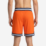 Back view of custom orange basketball shorts in orange with matching navy and white striped waistband and chevron hem trim