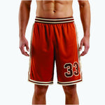 Custom orange basketball shorts with cream hex side panel and number 33 on the left thigh, front view