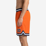 Second side view of custom orange basketball shorts displaying navy player number 00 on lower thigh and navy-white hem band with side split