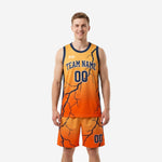 Custom orange basketball uniform with navy lightning crack pattern, crew neck jersey and matching shorts, front view on male model