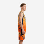 Side view of custom orange basketball uniform showing navy side panels and lightning crack sublimated design on jersey and shorts