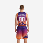Detail view of pixelated mountain graphic on lower front panel of custom orange basketball uniform and matching shorts