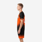 Men's custom orange soccer uniform side profile view displaying orange-to-black gradient jersey and matching shorts