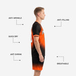 Custom orange black soccer kit shorts showing gradient fade from black waistband to orange hem with sublimated player number