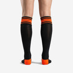 Orange and black soccer socks double stripe cuff band detail with athletic orange and jet black ribbed knit construction