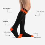Custom orange and black soccer socks heel and toe panel detail showing reinforced orange contrast zones on performance polyester knit