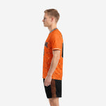 Custom orange soccer uniform right side view showing geometric grid pattern on jersey and orange grid detail on shorts