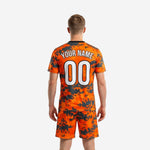 Orange digital camo custom soccer jersey front detail with white team name and player number sublimated print