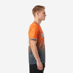 Close-up front view of orange charcoal gradient custom soccer jersey showing crew neck banding and diagonal wave panel design