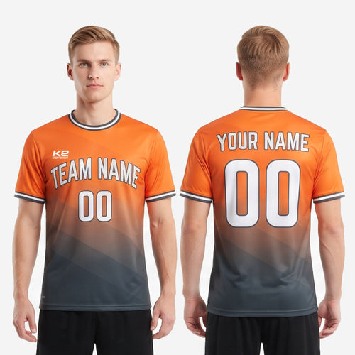Front and back view of custom orange and charcoal gradient soccer jersey with team name, front number, player name, and back number print zones