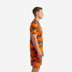 Men's custom orange soccer uniform side view showing full digital camo print on jersey and shorts
