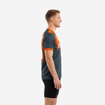 Custom orange soccer training jersey showing side profile with orange gradient shoulder panel and contrast sleeve cuff on male model