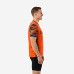 Custom orange soccer training jersey side view showing navy camo sleeve panel and side seam print