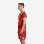 Custom orange soccer uniform right side view showing full-dye sublimation print on jersey and shorts