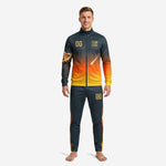 Custom orange soccer tracksuit with charcoal-to-gold gradient and comet sleeve detail, front view on adult male model
