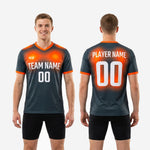 Back view of custom orange soccer training jersey showing player surname above number and orange gradient across shoulder zone