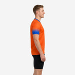 Custom orange soccer training jersey showing Royal Blue gradient sleeve fade from shoulder to cuff, side profile view