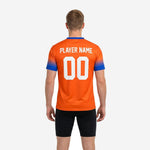 Close-up of custom orange soccer training jersey chest print zone showing team name and player number in white sublimated lettering
