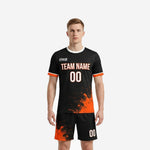 Front view of custom orange soccer uniform showing team name and number on black jersey with orange splash design