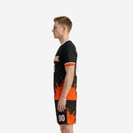 Close-up of custom orange soccer uniform jersey showing crew neck white trim and orange sleeve cuffs