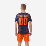 Custom orange soccer uniform navy jersey close-up showing team name and player number print zones with orange contrast trim