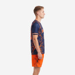 Custom orange soccer uniform navy lightning kit side view showing full-dye sublimation print on jersey and orange shorts