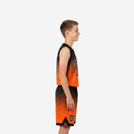 Front view of custom orange and black youth basketball uniform set with arced team name and front number on sublimated gradient jersey