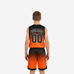 Opposite side view of custom orange youth basketball uniform set showing gradient pattern continuity from jersey shoulders to shorts hem