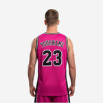 Opposite side view of custom sublimated pink basketball jersey with black armhole binding and white accent stripe detail visible on adult male player