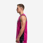 Side view of custom pink and black basketball jersey showing black side panel running from armhole to hem and tuck-in length on adult male