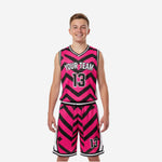 Custom pink and black youth basketball uniforms with bold chevron pattern, team name arc, and front and back player numbers - full set front and back view