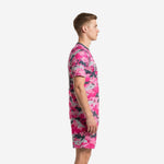 Custom pink soccer uniforms side view showing digital camo pattern across jersey and matching shorts on adult male model