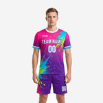 Custom pink and purple soccer uniforms with splash burst print, front view on male model showing team name and number sublimation