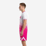 Custom pink soccer uniforms side view right displaying white chevron panel detail on hot pink shorts and player number on thigh