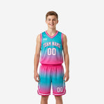 Custom pink youth basketball uniforms with teal-to-pink ombre gradient showing full 2-piece jersey and shorts set from front and back
