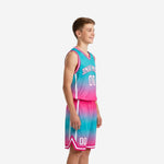 Front view of custom pink youth basketball uniforms featuring teal gradient jersey with arched team name and number 00 in white