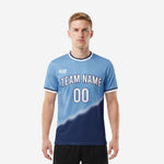 Custom powder blue and navy blue soccer jersey front view showing gradient sublimation, arched team name, and front number on male model